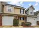 Charming townhome features neutral siding, a brick accent, and an attached one-car garage at 1386 Walnut Hill Dr, Rock Hill, SC 29732