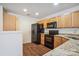 Functional kitchen with wood cabinets, granite countertops, and black appliances at 1386 Walnut Hill Dr, Rock Hill, SC 29732