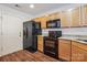 Functional kitchen with wood cabinets, granite countertops, and black appliances at 1386 Walnut Hill Dr, Rock Hill, SC 29732