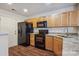 Functional kitchen with wood cabinets, granite countertops, and black appliances at 1386 Walnut Hill Dr, Rock Hill, SC 29732