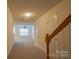 Hallway view to living room featuring neutral carpet, ceiling fan, and ample natural light at 1386 Walnut Hill Dr, Rock Hill, SC 29732