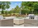 Backyard space with comfortable seating and a fire pit with mature trees at 145 Milford Cir, Mooresville, NC 28117