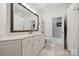 Classic bathroom with white cabinets, dual sinks, framed mirror, and separate toilet room at 145 Milford Cir, Mooresville, NC 28117