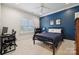 Comfortable bedroom featuring a blue accent wall, ceiling fan, and bright natural light at 145 Milford Cir, Mooresville, NC 28117
