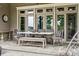A furnished outdoor dining area on a covered patio featuring gray slate tile and neutral furnishings at 145 Milford Cir, Mooresville, NC 28117