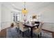 Elegant dining room featuring a chandelier, wainscoting, and a large window for natural light at 145 Milford Cir, Mooresville, NC 28117