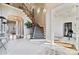 Elegant foyer with curved staircase, detailed millwork, light tile flooring, and an inviting open floor plan at 145 Milford Cir, Mooresville, NC 28117