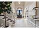 Grand foyer featuring tile floors, staircase, an arched doorway, and modern decor at 145 Milford Cir, Mooresville, NC 28117
