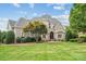 Charming home with manicured lawn, stone accents, mature landscaping, and classic architectural details at 145 Milford Cir, Mooresville, NC 28117