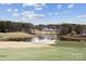 Picturesque golf course view with a serene lake and lush green fairways under a bright, cloudy sky at 145 Milford Cir, Mooresville, NC 28117