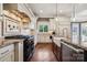 Custom kitchen with stainless steel appliances, granite countertops, and designer finishes at 145 Milford Cir, Mooresville, NC 28117