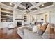 Bright living room featuring a fireplace, built-in shelves, and coffered ceilings at 145 Milford Cir, Mooresville, NC 28117