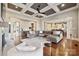 Spacious living room features hardwood floors, coffered ceiling, and seamless flow into the open kitchen at 145 Milford Cir, Mooresville, NC 28117