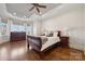 Spacious main bedroom with hardwood floors, tray ceiling, ceiling fan, and bay window at 145 Milford Cir, Mooresville, NC 28117