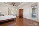 Relaxing main bedroom with hardwood floors, tray ceiling, ceiling fan, and door to porch at 145 Milford Cir, Mooresville, NC 28117