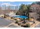 Aerial view of community pool, playground, parking lot and clubhouse surrounded by landscaping at 18016 Bluff Inlet Rd, Cornelius, NC 28031