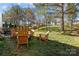 Backyard with a fire pit and Adirondack chairs creating a cozy outdoor space with privacy fence at 18016 Bluff Inlet Rd, Cornelius, NC 28031