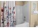Bathroom featuring a white shower-tub combo with flower-patterned shower curtain at 18016 Bluff Inlet Rd, Cornelius, NC 28031