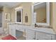 Well-lit bathroom with double sinks, white cabinets, and large mirrors at 18016 Bluff Inlet Rd, Cornelius, NC 28031