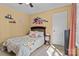 Cozy bedroom featuring a bed with a floral comforter and a ceiling fan at 18016 Bluff Inlet Rd, Cornelius, NC 28031