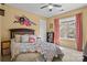 Bedroom with a floral comforter, a ceiling fan, and a large window at 18016 Bluff Inlet Rd, Cornelius, NC 28031