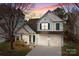 Charming two-story home with a two-car garage and beautiful sunset sky at 18016 Bluff Inlet Rd, Cornelius, NC 28031