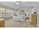 Spacious primary bedroom with carpet and large windows offering natural light at 18016 Bluff Inlet Rd, Cornelius, NC 28031