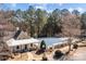 Aerial view of a community pool surrounded by lush trees and landscaping at 18016 Bluff Inlet Rd, Cornelius, NC 28031