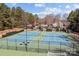 Scenic aerial view of community tennis courts surrounded by manicured landscaping and mature trees at 18016 Bluff Inlet Rd, Cornelius, NC 28031
