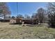 View of the brick home's back exterior showing yard, trees, and a patio area at 1961 Franklin St, Rock Hill, SC 29732