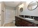 Well-lit bathroom featuring a double sink vanity with round mirrors and a shower-tub combo at 1961 Franklin St, Rock Hill, SC 29732
