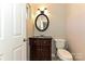 Well-lit half bathroom featuring a dark wood vanity, updated lighting, and modern fixtures at 1961 Franklin St, Rock Hill, SC 29732