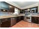 Updated kitchen showcasing stainless steel appliances, unique backsplash, and dark wood cabinets at 1961 Franklin St, Rock Hill, SC 29732