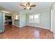 Open living room with hardwood floors, a ceiling fan, and stainless steel appliances in the kitchen at 1961 Franklin St, Rock Hill, SC 29732