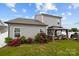 Well-maintained backyard with gray siding, gazebo, and red roses, creating a peaceful outdoor living space at 201 Bennett Trail Dr, Mount Holly, NC 28120