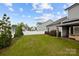 Large grassy backyard with a covered gazebo and white fence in background at 201 Bennett Trail Dr, Mount Holly, NC 28120
