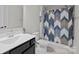 Bathroom features blue patterned shower curtain and dark colored cabinets at 201 Bennett Trail Dr, Mount Holly, NC 28120