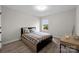 Bright bedroom features wood floors and lots of light from the window at 201 Bennett Trail Dr, Mount Holly, NC 28120