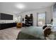 Spacious bedroom features wood floors, shoe shelving, and lots of natural light at 201 Bennett Trail Dr, Mount Holly, NC 28120