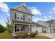 Charming gray two-story home with a two-car garage and a welcoming front porch at 201 Bennett Trail Dr, Mount Holly, NC 28120
