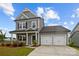 Charming gray two-story home with a two-car garage and a welcoming front porch at 201 Bennett Trail Dr, Mount Holly, NC 28120