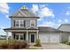 Charming gray two-story home with a two-car garage and a welcoming front porch at 201 Bennett Trail Dr, Mount Holly, NC 28120