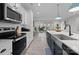 Gourmet kitchen boasts stainless steel appliances, subway tile backsplash, and a marble countertop island at 201 Bennett Trail Dr, Mount Holly, NC 28120