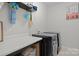 Well-organized laundry room featuring modern washer and dryer, countertop, and storage space, for convenient laundry care at 201 Bennett Trail Dr, Mount Holly, NC 28120