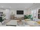 Open-concept living room featuring a large TV, stylish shelving, and abundant natural light at 201 Bennett Trail Dr, Mount Holly, NC 28120