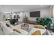 Open living space with a large television, kitchen island, and decorative plants at 201 Bennett Trail Dr, Mount Holly, NC 28120