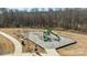 Aerial view of a well-maintained community playground with a slide, swings, and climbing structures for active play at 201 Bennett Trail Dr, Mount Holly, NC 28120