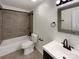 A bathroom featuring modern fixtures, tile floors and a bathtub with tile surround at 205 Mauney St, Mount Holly, NC 28120