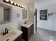 Bathroom featuring double sinks, modern fixtures, and neutral color palette at 205 Mauney St, Mount Holly, NC 28120
