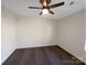Bedroom with hardwood floors, neutral walls, ceiling fan, and natural light at 205 Mauney St, Mount Holly, NC 28120